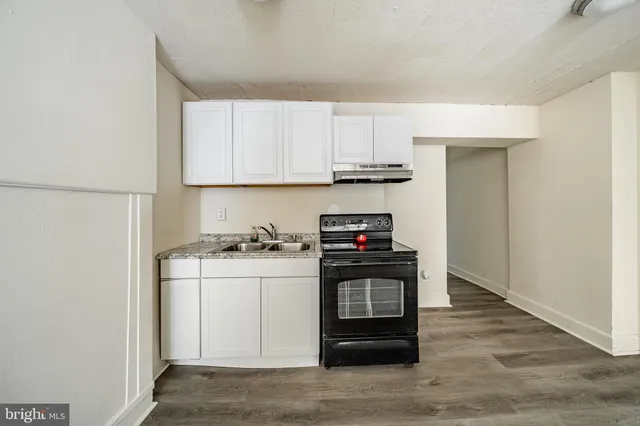 a kitchen with stainless steel appliances granite countertop a stove a refrigerator and a sink