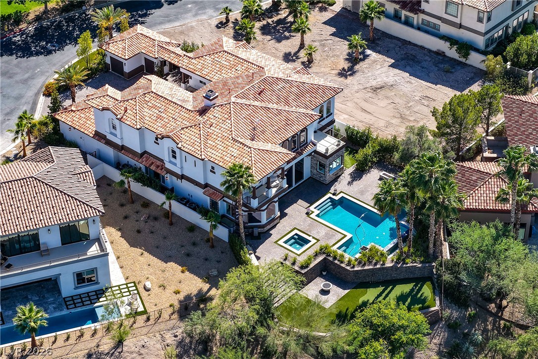 6 Rue Du Ville Henderson, NV 89011 - Photo 90 of 99 An aerial view showcases a grand residence with a beautiful pool and ample outdoor spaces.