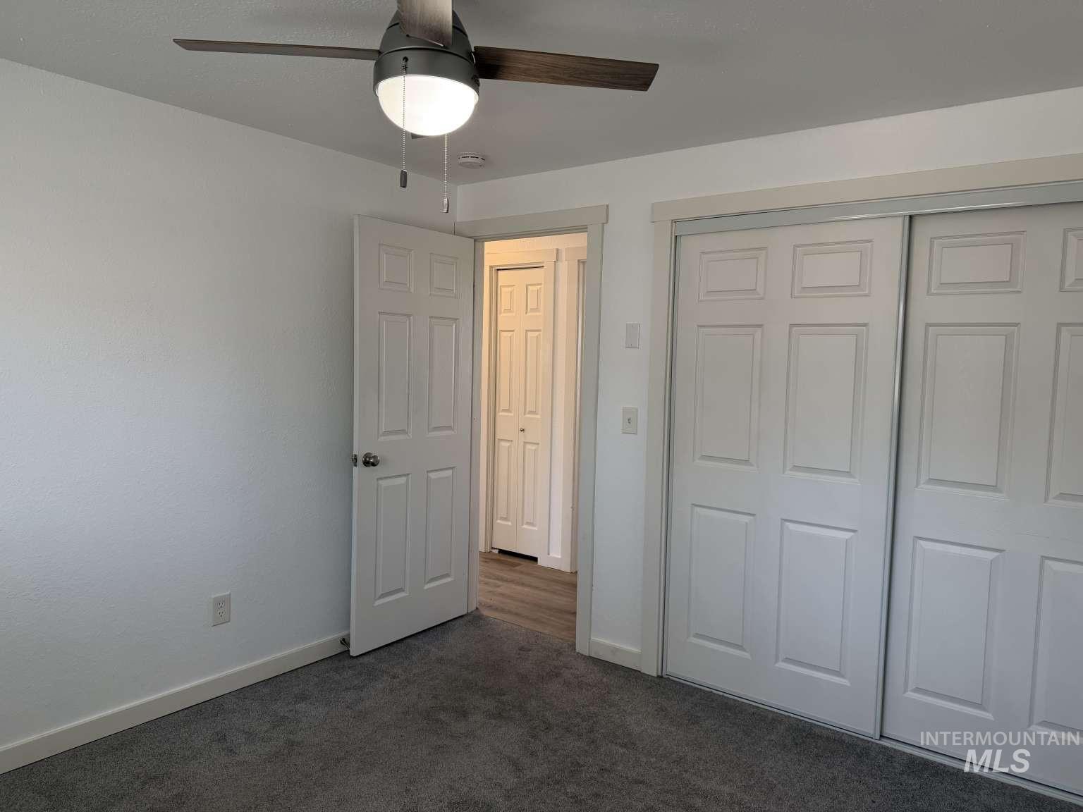 211 Jasper Avenue Middleton, ID 83644 - Photo 14 of 25 Unfurnished bedroom with dark colored carpet, a closet, and a ceiling fan