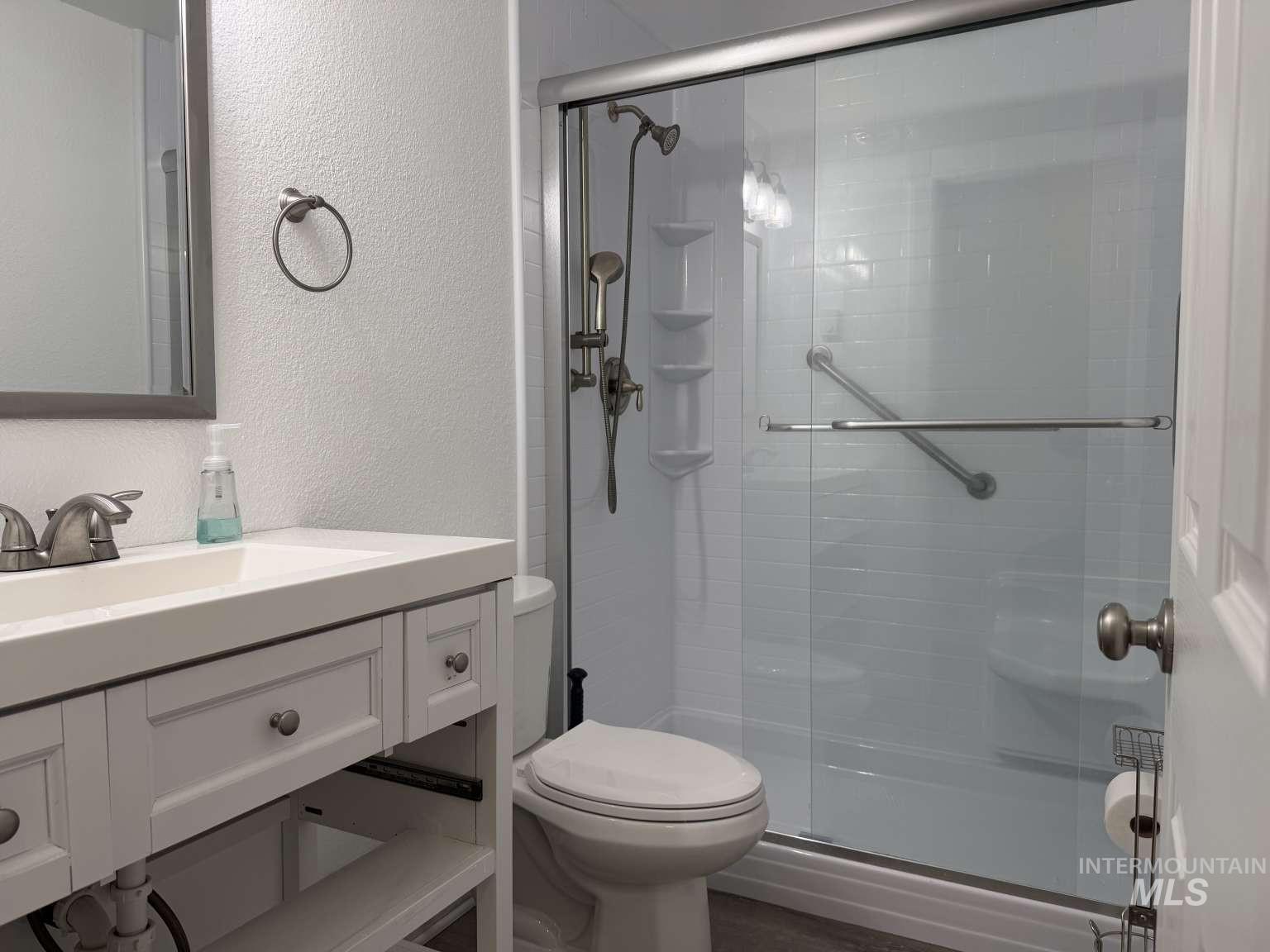 211 Jasper Avenue Middleton, ID 83644 - Photo 19 of 25 Bathroom with a textured wall, vanity, and a stall shower