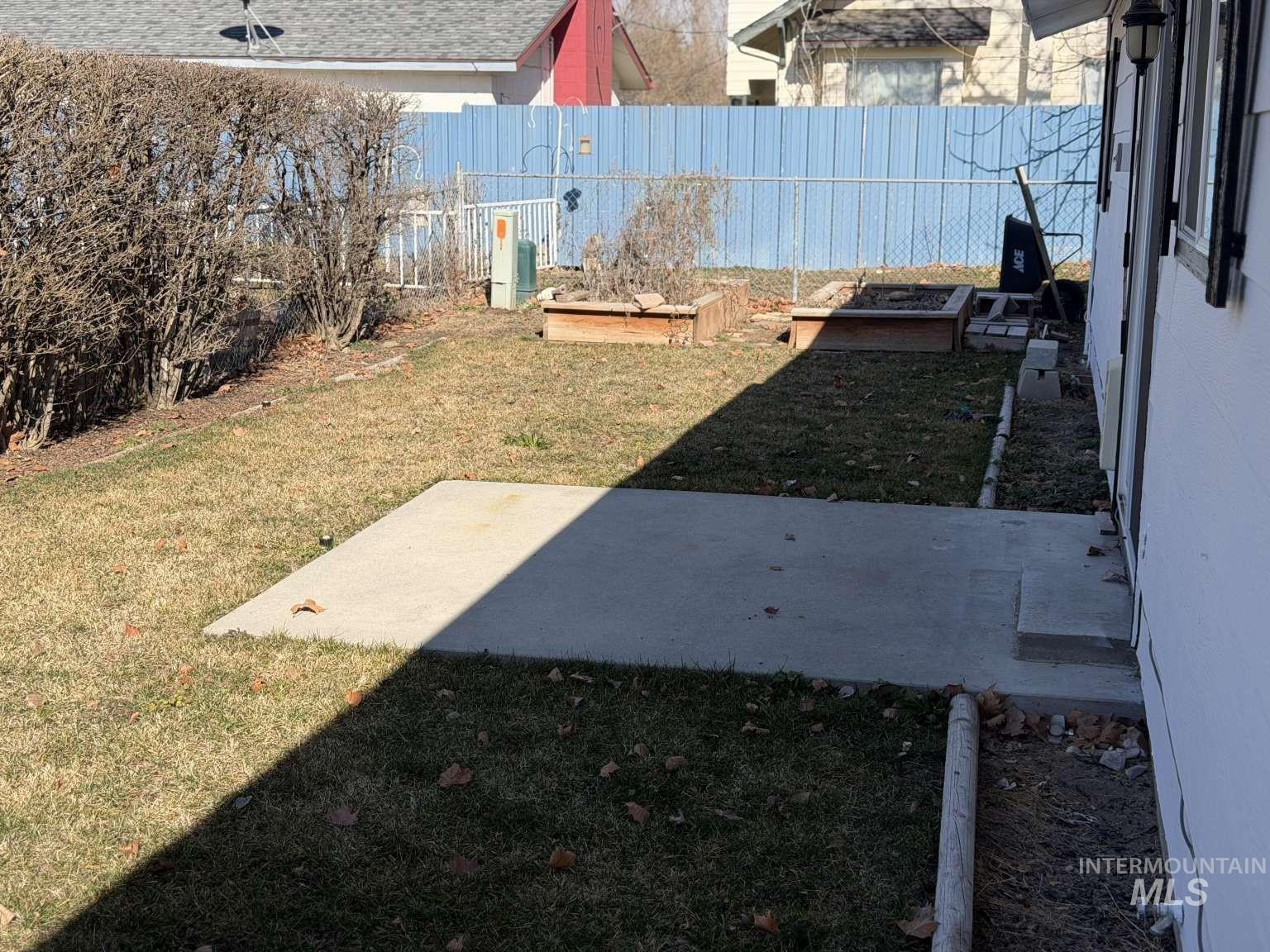 211 Jasper Avenue Middleton, ID 83644 - Photo 22 of 25 Fenced backyard featuring a patio area and a vegetable garden