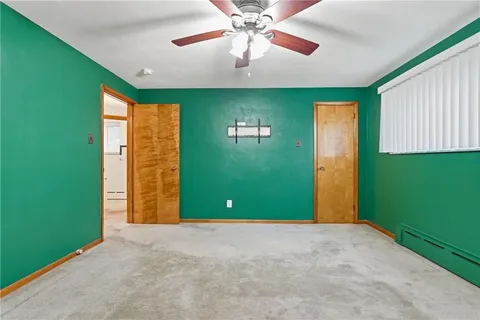 a view of a livingroom with a ceiling fan and window