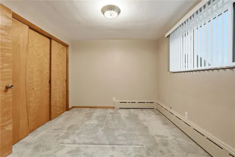 a view of a room with rack on the wall and a window