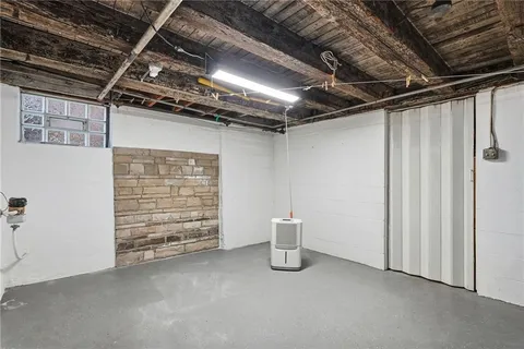 a view of an empty room with a white car parked