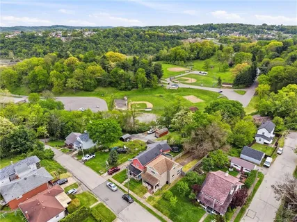 an aerial view of residential houses with outdoor space and river