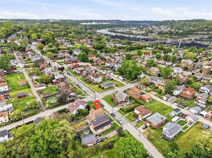 an aerial view of residential building with parking