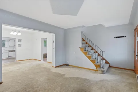 a view of an empty room with a staircase