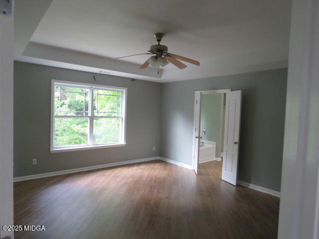 776 Ivy Brook Way Macon, GA 31210 - Photo 14 of 21 an empty room with wooden floor chandelier fan and windows