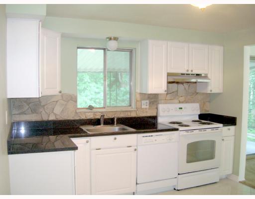 137 Parkedge Road Green Tree, PA 15220 - Photo 5 of 8 Kitchen. Kitchen with newer white cabinets, black granite counters, white ceramic tile floor, newer electric stove, newer dishwasher, sage green walls.