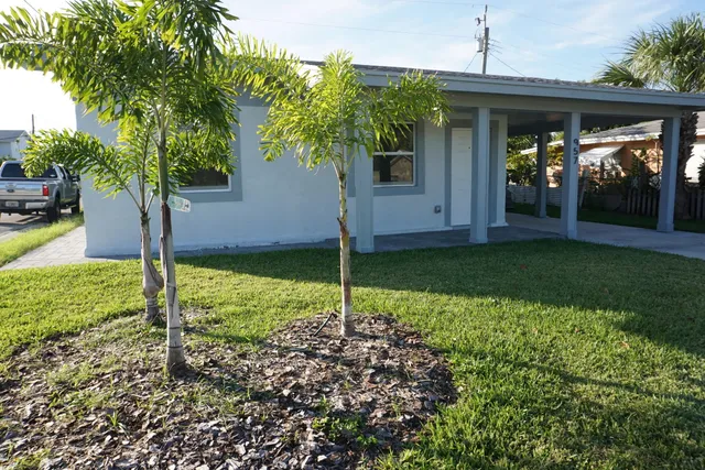 a house is sitting in middle of the garden