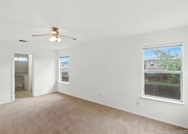 an empty room with windows and closet