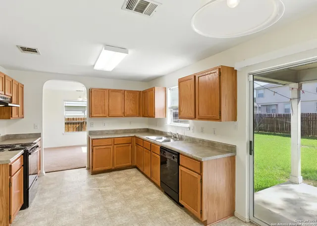 a kitchen with stainless steel appliances granite countertop a stove and a sink