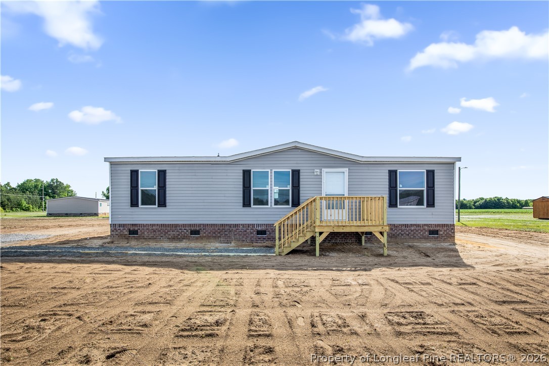 6309 Deep Branch Road Pembroke, NC 28372 - Photo 1 of 32 a front view of a house with a yard