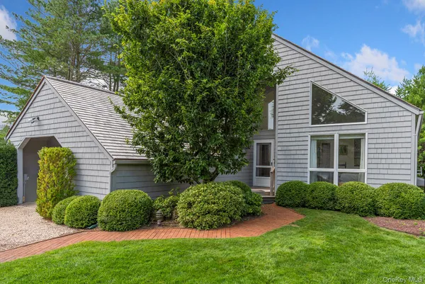 a view of a house with a yard and plants