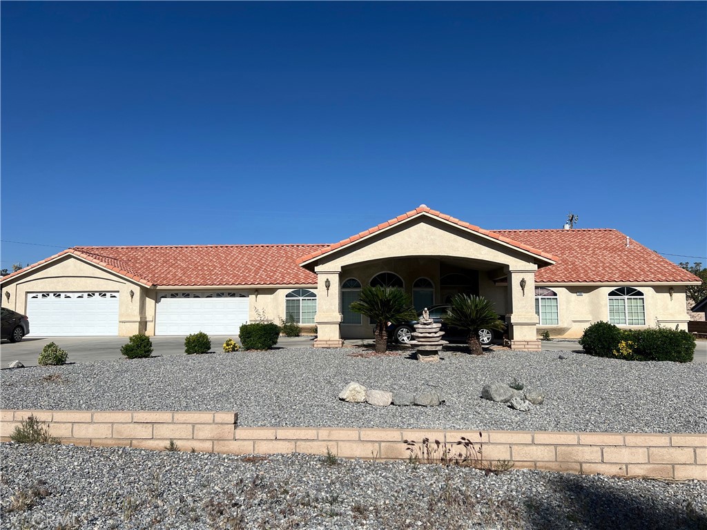 13881 Choco Road Apple Valley, CA 92307 - Photo 1 of 1 a front view of a house with a yard