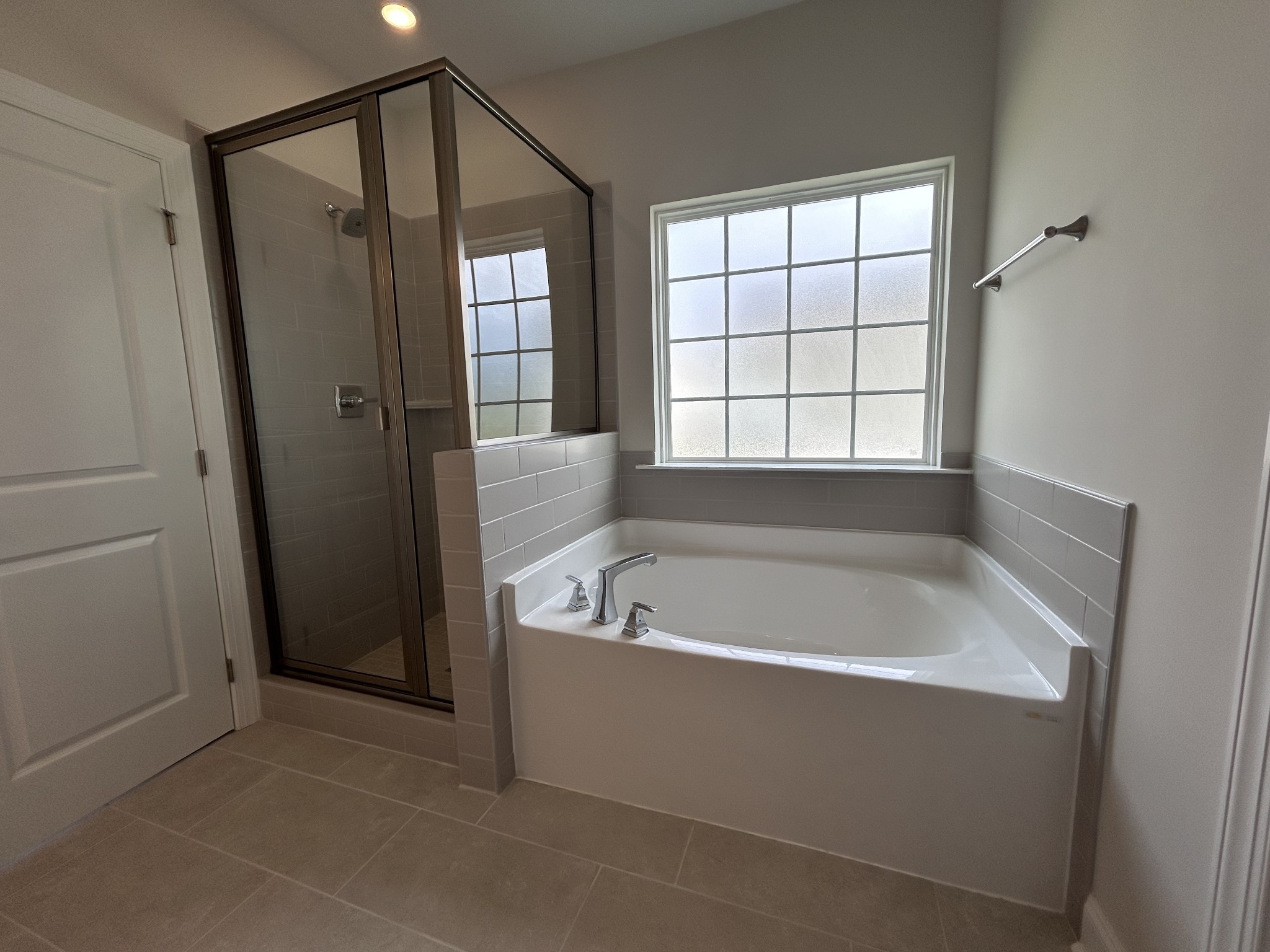 6502 Ripple Ridge Columbia, TN 38401 - Photo 24 of 52 a white bath tub sitting in a bathroom next to a window