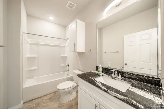 an empty room with a window and a ceiling fan