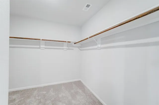 a view of kitchen with stainless steel appliances cabinets and wooden floor