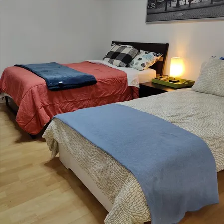 a bedroom with two beds and a couch
