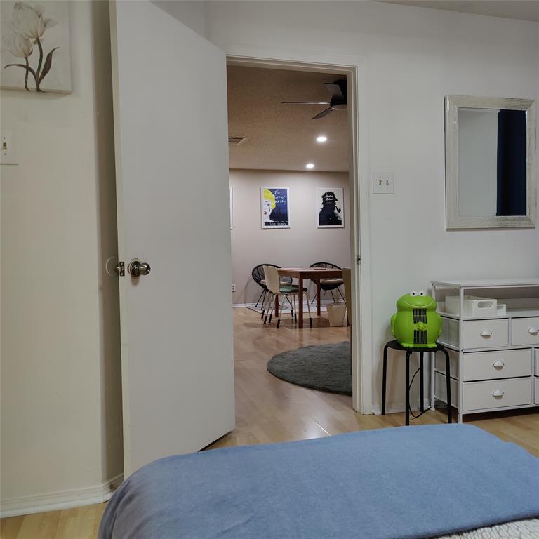 18333 Roehampton Drive Dallas, TX 75252 - Photo 9 of 10 a bedroom with furniture and a wooden floor