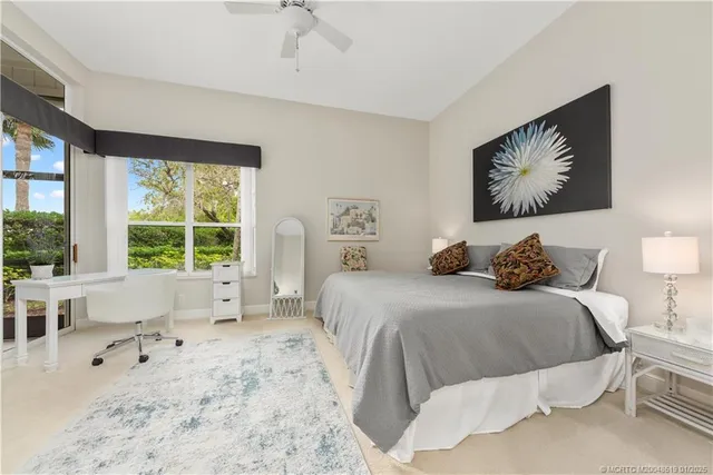 a bedroom with a large bed and a large window