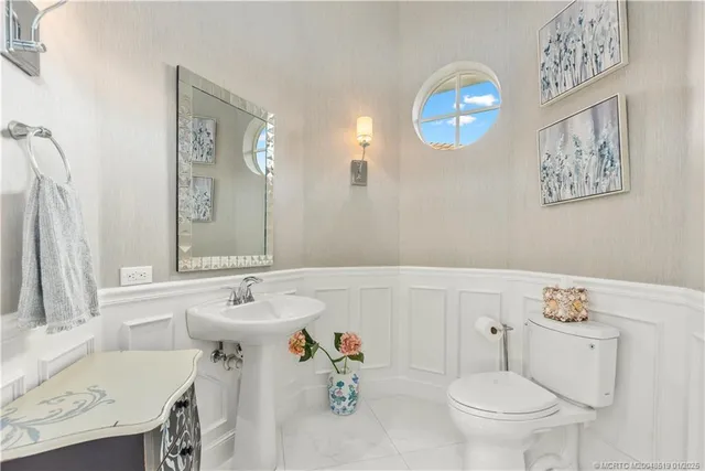 a bathroom with a sink toilet and a mirror