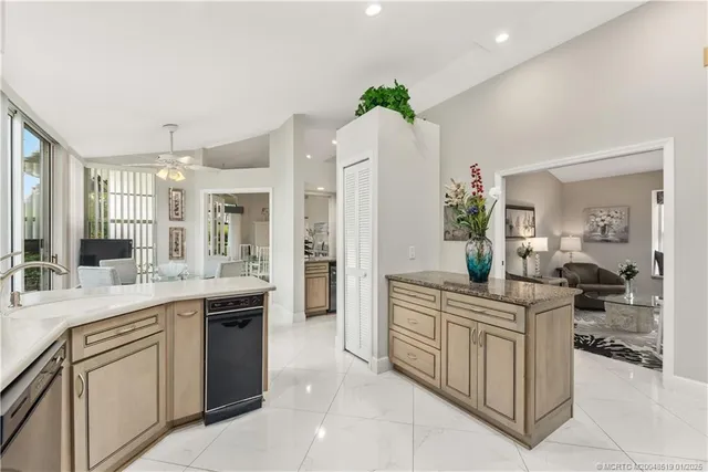 a large kitchen with cabinets and wooden floor