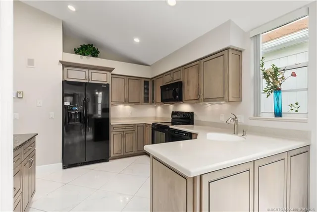 a kitchen with a sink stainless steel appliances and counter space