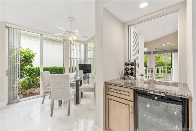 a dining hall with stainless steel appliances granite countertop a stove a chimney a sink and dishwasher