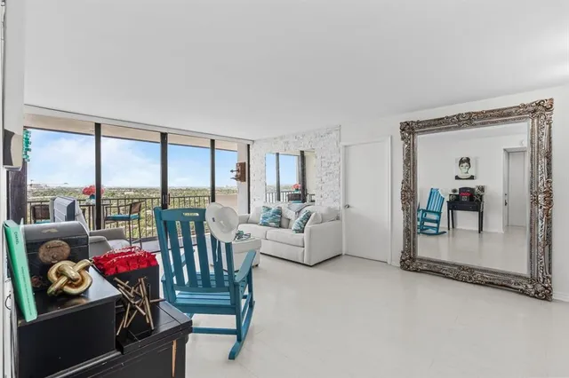 a living room with furniture and a floor to ceiling window