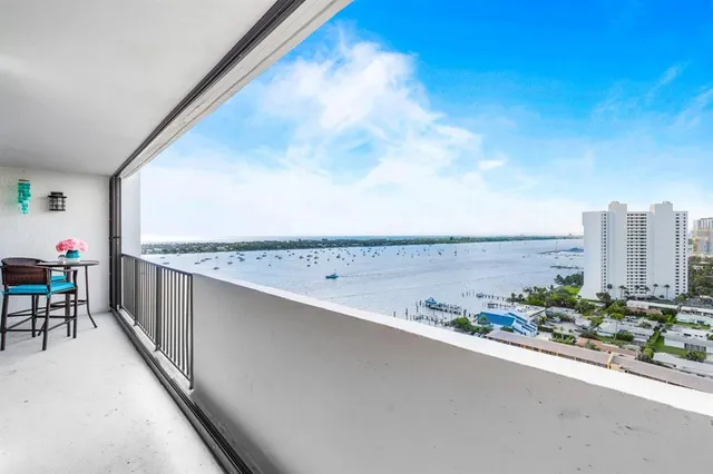 a view of a terrace with furniture and city view