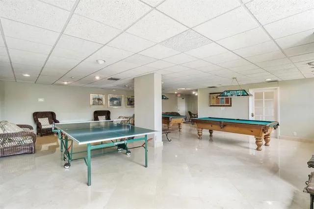 a room with furniture and pool table