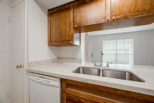 a kitchen with a sink cabinets and window
