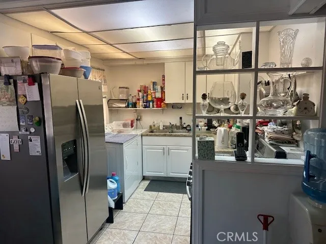 a bed sitting in a bedroom next to a window and tv