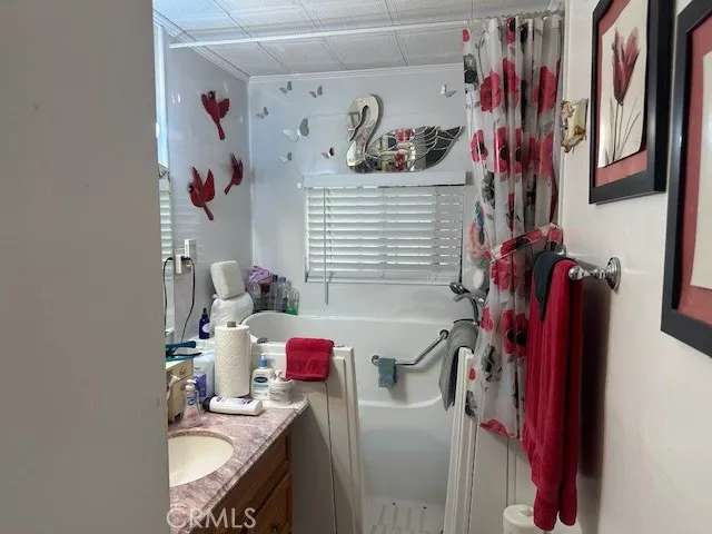 a bathroom with mirror and shower