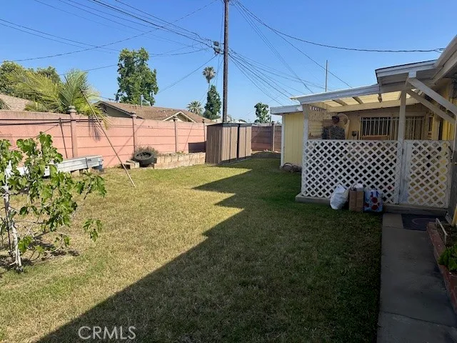 a view of a backyard with plants and a patio