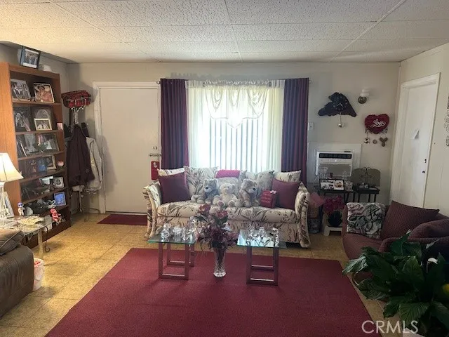 a living room with furniture a lamp and a bookshelf