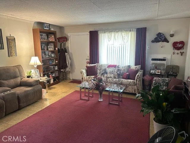 a living room with furniture a window and a chandelier
