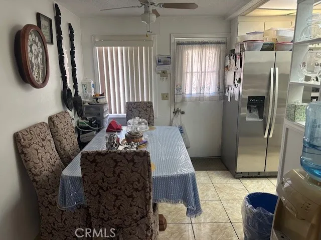 a kitchen with refrigerator and cabinets