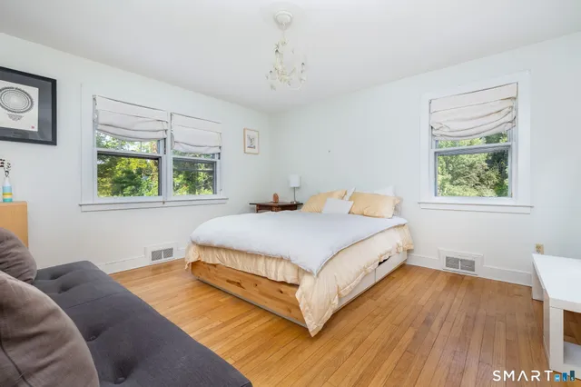 a bedroom with a bed and window