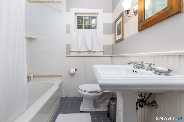 a bathroom with a sink a toilet and a bathtub