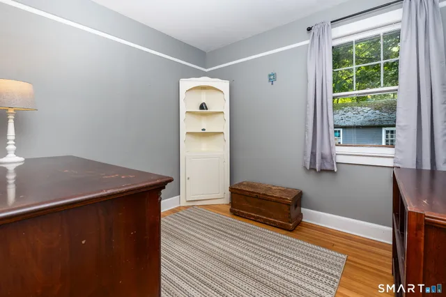 a view of room with furniture and wooden floor