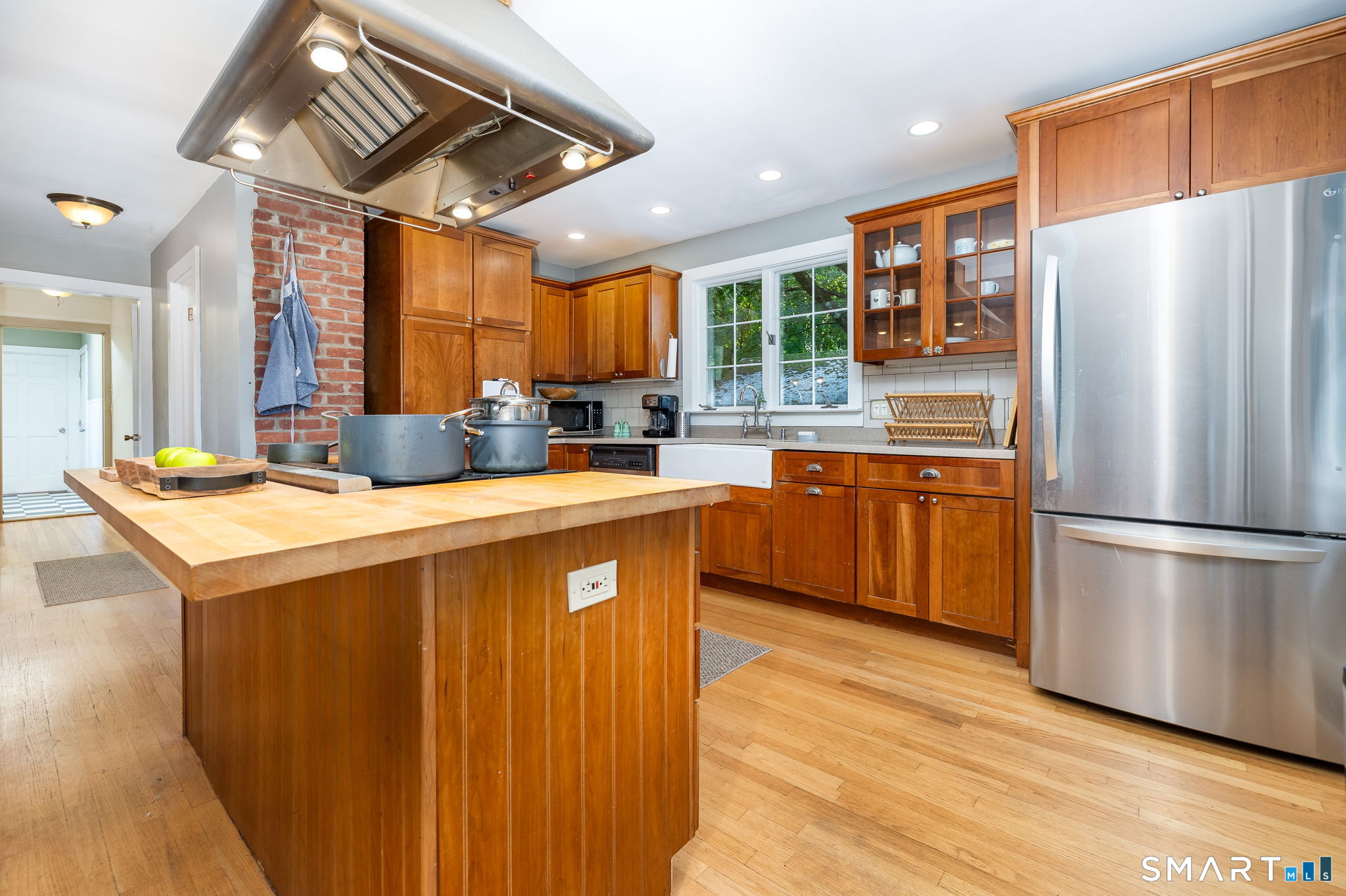 256 Baldwin Hill Road Washington, CT 06777 - Photo 6 of 22 a kitchen with stainless steel appliances granite countertop a refrigerator a sink a stove and a wooden floors