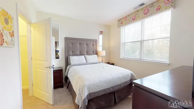 a bedroom with a bed and a window