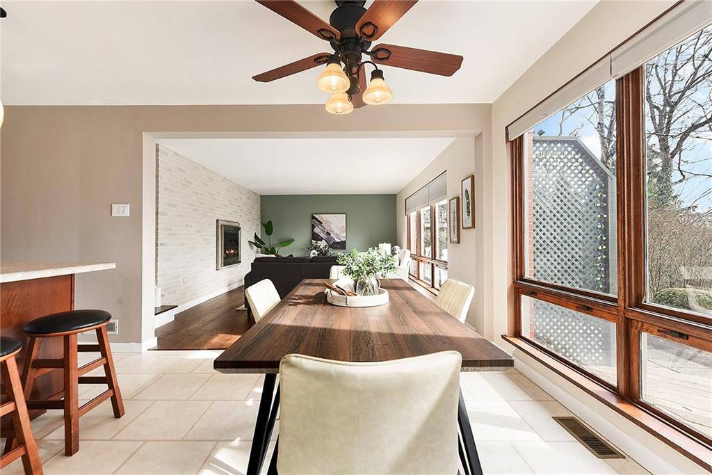 6913 Merton Road Pittsburgh, PA 15202 - Photo 18 of 48 a view of a dining room with furniture a chandelier and wooden floor