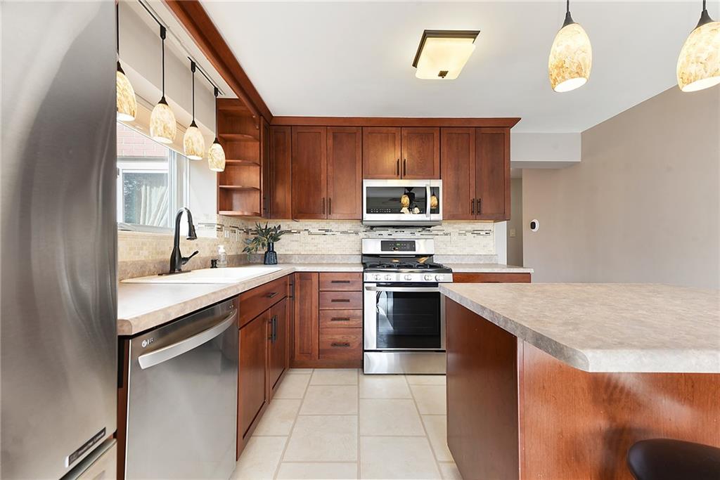 6913 Merton Road Pittsburgh, PA 15202 - Photo 20 of 48 a kitchen with stainless steel appliances granite countertop a sink counter space cabinets and a stove