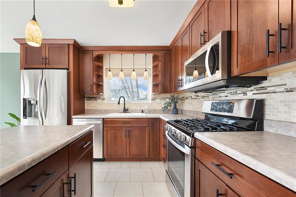 6913 Merton Road Pittsburgh, PA 15202 - Photo 22 of 48 a kitchen with stainless steel appliances granite countertop a sink stove and refrigerator