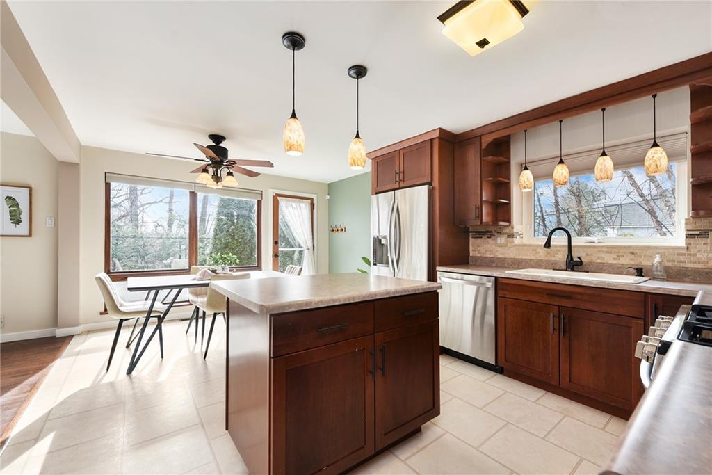 6913 Merton Road Pittsburgh, PA 15202 - Photo 23 of 48 a kitchen with a table chairs sink and wooden floor