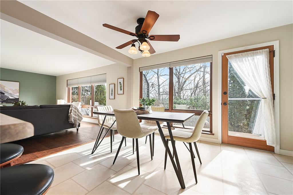 6913 Merton Road Pittsburgh, PA 15202 - Photo 24 of 48 a dining room with furniture a chandelier and wooden floor