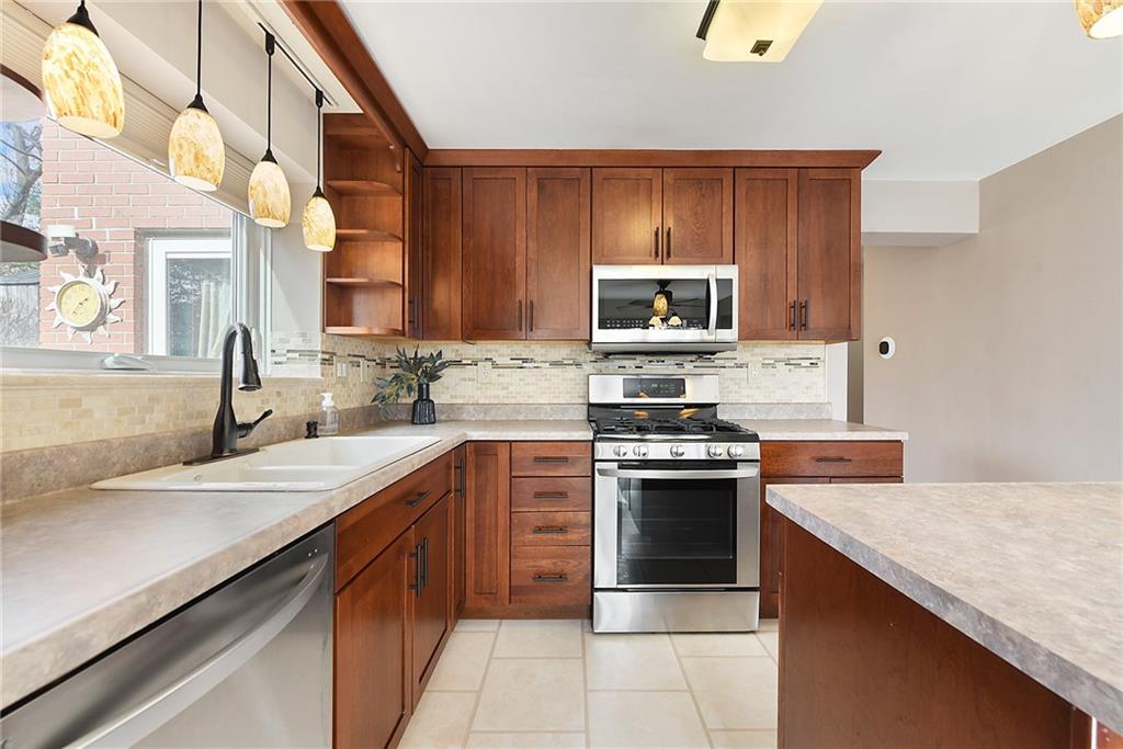 6913 Merton Road Pittsburgh, PA 15202 - Photo 25 of 48 a kitchen with a sink stove and microwave